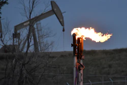 A flare to burn methane from oil production is seen on a well pad near Watford City, North Dakota, Aug. 26, 2021. A huge social and environmental policy bill passed by House Democrats includes a plan to impose a fee on emissions of methane, a powerful pollutant that leaks from oil and gas wells and contributes to global warming.