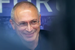 Russian opposition figure and former owner of the Yukos Oil Company Mikhail Khodorkovsky smiles during a news conference after the Vilnius Russia Forum at the 'Esperanza' hotel in Paunguriai village, Trakai district west of the capital Vilnius, Lithuania, on Aug. 20, 2021. The Dutch Supreme Court is ruling Friday, Nov. 5, 2021 in a $50 billion legal battle between Russia and former shareholders of the country's bankrupted oil giant Yukos.