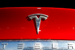 The Tesla company logo sits on an unsold 2020 Model X at a Tesla dealership in Littleton, Colo., on Feb. 2, 2020. Tesla has issued a recall that will automatically send a software update fixing a safety problem in its electric vehicles. The recall on Tuesday, Nov. 2, 2021, apparently heads off a looming confrontation with U.S. safety regulators.