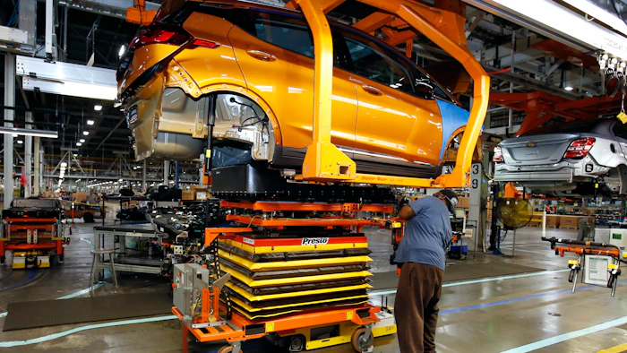 A battery is lifted into place for installation in a Chevrolet Bolt EV at the General Motors Orion Assembly plant, Nov. 4, 2016, Orion Township, Mich.