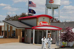 In this May 7, 2020 photo, workers leave the Tyson Foods pork processing plant in Logansport, Ind.