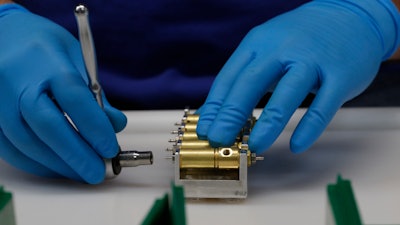 A ventilator is assembled at the Ford Rawsonville plant, May 13, 2020, in Ypsilanti Township, Mich. Commerce Secretary Gina Raimondo on Monday, Dec. 13, 2021, is announcing 60 finalists for $1 billion in economic development grants tied to the Biden administration's coronavirus relief package and aimed at improving job training and regional industry partnerships.