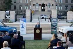 Georgia Gov. Brian Kemp, flanked by Rivian electric trucks, at a press conference in Atlanta, Dec. 16, 2021.