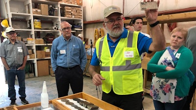 NioCorp Corporate Controller Jeff Mason shows investors a rock sample in Elk Creek, Neb., Oct. 6, 2021.