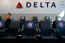 A passenger wears a face mask as she waits in a socially-distance area for a Delta Airlines flight, Wednesday, Feb. 3, 2021, at Hartsfield-Jackson International Airport in Atlanta. Delta Airlines is reversing course on its outlook for the fourth quarter, now saying that it anticipates a profit instead of a loss. The company said Thursday, Dec. 16, that it now foresees an adjusted profit of approximately $200 million for the period.