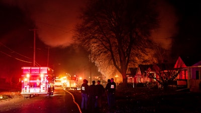 Emergency personnel are shown at the scene of a fire and explosion at a home in Flint, Mich., Monday night, Nov. 22, 2021. Three people were missing following the fire and explosion, authorities said.