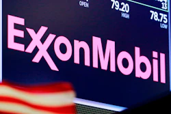 The logo for ExxonMobil appears above a trading post on the floor of the New York Stock Exchange, April 23, 2018. ExxonMobil says it is boosting its spending on greenhouse gas emission-reduction projects to $15 billion over the next six years and anticipates meeting its 2025 greenhouse gas emission-reduction plans by the end of this year.