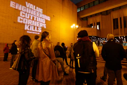 People attend a rally outside Kensington Town Hall to bring attention to the lack of support and action over the Grenfell Tower fire, in London, Sunday Nov. 14, 2021. In 2017 a small kitchen fire in the west London public-housing block turned into the worst domestic blaze in the country since World War II.