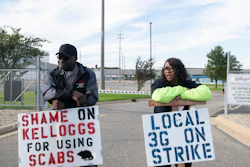 Larry Gamble, who has worked at the Kellogg plant for 13 years, and Sharnita Childress, who has worked at the plant for 8 years, picket with other union workers outside of the plant in Battle Creek, Mich. on Oct. 19, 2021.
