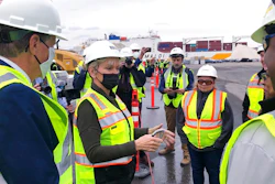 U.S. Energy Secretary Jennifer Granholm, center, speaks with workers, and Rhode Island Gov. Dan McKee, left, Thursday Dec. 2, 2021, while visiting an under construction fabrication and assembly facility for offshore wind turbines at the Port of Providence, in Providence, R.I. The building is scheduled to be finished this spring to support two offshore wind projects, Revolution Wind and South Fork Wind.