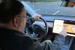 Vince Patton, a new Tesla owner, demonstrates on Wednesday, Dec. 8, 2021, on a closed course in Portland, Ore., how he can play video games on the vehicle's console while driving. Patton, of Portland, Ore., filed a complaint with federal regulators after discovering the feature in his new car.