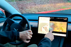 Vince Patton, a new Tesla owner, demonstrates on Dec. 8, 2021, on a closed course in Portland, Ore., how he can play video games on the vehicle's console while driving. The U.S. has opened a formal investigation into a report that Tesla vehicles allow people to play video games on a center touch screen while they are driving.