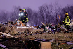 Firefighters search a debris field that came from a house that was ripped off its foundation and trees were cut off after a tornado ripped along Highway F at the intersection of Stub Road in St. Charles County, Mo., on Friday, Dec. 10, 2021.