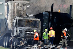 Workers clear debris from the eastbound lanes of Interstate 70 on April 26, 2019, in Lakewood, Colo., following a deadly pileup involving a semi-truck hauling lumber. A truck driver who was convicted of causing the fiery pileup that killed four people and injured six others on Interstate 70 west of Denver was sentenced Monday, Dec. 13, 2021, to 110 years in prison. Rogel Aguilera-Mederos was convicted in October of vehicular homicide and other charges stemming from the April 2019 crash.
