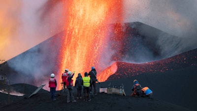 Scientists from CSIC (Spanish National Research Council) take geophysics measurements on the Canary Island of La Palma, Spain, Saturday, Nov. 13, 2021. They come with eagle-eyed drones and high-precision spectrometers. Aided by satellites, they analyze gas emissions and the extent and direction of molten rock flows.