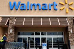 In this May 9, 2013, file photo, a worker pushes shopping carts in front of a Wal-Mart store in La Habra, Calif. Retail giant Walmart illegally dumps more 1 million batteries, aerosol cans of insect killer and other products, toxic cleaning supplies, electronic waste, latex paints and other hazardous waste into California landfills each year, state prosecutors alleged in a lawsuit filed Monday, Dec. 20, 2021.