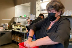 Folsom Vice Mayor Sarah Aquino wrings out a rag before cleaning a table at Back Bistro in Folsom, Calif., on Tuesday, Nov. 23, 2021. Aquino is an insurance broker. But she took a part-time job at one of her favorite local restaurants because they were struggling to hire people. Employers have reported a shortage of workers to meet demand as more people return to normal habits following the disruption of the coronavirus pandemic. Aquino sees it as her civic duty to help out local businesses.
