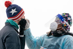 A man is swabbed for COVID-19 at a walk-up testing site at Farragut Square on Dec. 23, 2021, just blocks from the White House in Washington. The explosive increase in U.S. coronavirus case counts is raising alarm, but some experts believe the focus should instead be on COVID-19 hospital admissions. And those aren't climbing as fast.