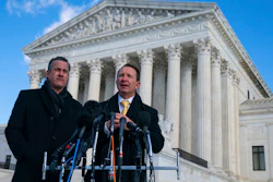 Louisiana Attorney General Jeff Landry talks to reporters outside the Supreme Court after arguments about whether to allow the administration to enforce a vaccine-or-testing requirement that applies to large employers and a separate vaccine mandate for most health care workers on Jan. 7, 2022, in Washington. At left is deputy Louisiana Attorney General Bill Stiles.