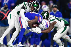 New York Jets Brandin Echols, left, and Quincy Williams, right, tackle the Buffalo Bills' Stefon Diggs during the first half of a game in Orchard Park, N.Y., Jan. 9, 2022.