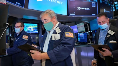 Traders Edward McCarthy, center, and Edward Curran, right, on the floor of the New York Stock Exchange, Jan. 10, 2022.