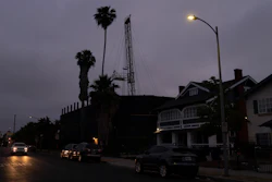 A vehicle drives past the Jefferson oil drill site in Los Angeles, June 2, 2021.