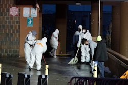 Staffs cleans the floor at the scene of a fatal fire at an apartment building in the Bronx on Sunday, Jan. 9, 2022, in New York.