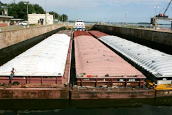 A towboat and its barges are shown in the channel at lock and dam 25 at Winfield, Mo., on Aug. 19, 2005. The U.S. Army Corps will spend $732 million to expand the congested lock and dam in Missouri. Federal officials said adding a second lock in Winfield will reduce travel time for barges and allow for two-way traffic. Funding for the lock's construction was part of a broader Biden administration announcement Wednesday, Jan. 19, 2022, to provide the Army Corps with $14 billon for infrastructure and environmental restoration projects.