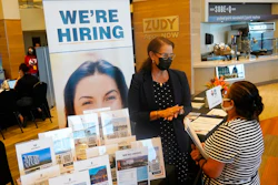 Marriott human resources recruiter Mariela Cuevas, left, talks to Lisbet Oliveros, during a job fair at Hard Rock Stadium, Friday, Sept. 3, 2021, in Miami Gardens, Fla. Federal Reserve policymakers at a meeting last month said the U.S. job market was nearly at levels healthy enough that the central bank's low-interest rate policies were no longer needed. That's according to minutes of the meeting released Wednesday, Jan. 5, 2022.
