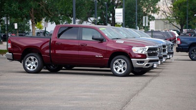Only a handful of unsold 2021 Ram pickup trucks sit on the empty storage lot outside a Ram dealership on Sunday, Aug. 29, 2021, in Littleton, Colo.