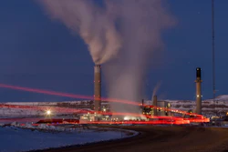 In this photo taken with a slow shutter speed, taillights trace the path of a motor vehicle at the Naughton Power Plant, Thursday, Jan. 13, 2022 in Kemmerer, Wyo. While the power plant will be closed in 2025, Bill Gates' company TerraPower announced it had chosen Kemmerer for a nontraditional, sodium-cooled nuclear reactor that will bring on workers from a local coal-fired power plant scheduled to close soon.