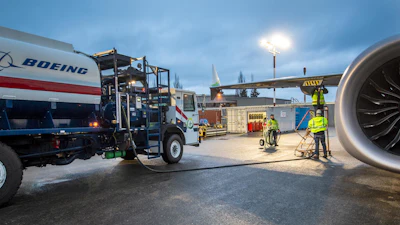 An aviation maintenance team loads sustainable aviation fuel into the 2021 Boeing ecoDemonstrator.