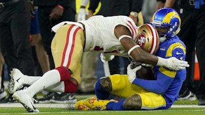 The San Francisco 49ers' Jimmie Ward, left, is called for a penalty as he hits the Los Angeles Rams' Odell Beckham Jr. during the NFC championship game, Inglewood, Calif., Jan. 30, 2022.