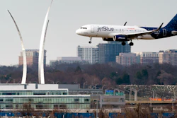 Passenger flights land and take off at Reagan Washington National Airport, Arlington, Va., Jan. 19, 2022.