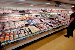 A man looks at beef in the meat department at Lambert's Rainbow Market on June 15, 2021 in Westwood, Mass.