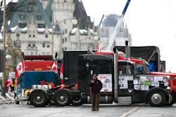 Trucks are parked in front of the Chateau Laurier as a protest against COVID-19 restrictions continue in Ottawa on Feb. 10, 2022.