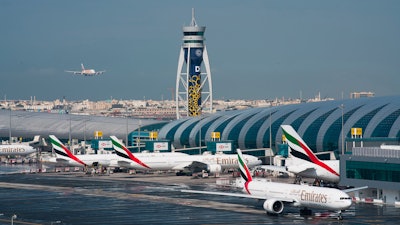 An Emirates jetliner comes in for landing at Dubai International Airport, Dec. 11, 2019.