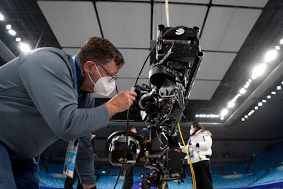Associated Press photographer David J. Phillip sets up a robotic camera for figure skating ahead of the 2022 Winter Olympics, Saturday, Jan. 22, 2022, in Beijing.