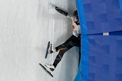 Sumire Kikuchi, of Japan, crashes in the quarterfinals of women's 1,000-meter during the short track speedskating competition at the 2022 Winter Olympics, Friday, Feb. 11, 2022, in Beijing.