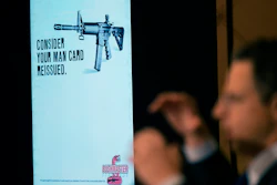 An ad for an AR-15-style rifle is displayed while attorney Josh Koskoff speaks during a news conference, Trumbull, Conn., Feb. 15, 2022.
