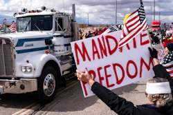 Supporters cheer on the beginning of a trucker caravan to Washington, D.C., called The People's Convoy on Feb. 23, 2022, in Adelanto, Calif. A small convoy of truckers demanding an end to coronavirus mandates began a cross-country drive from California to the Washington, D.C., area on Wednesday.