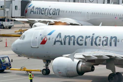 American Airlines passenger jets prepare for departure, on July 21, 2021, at Boston Logan International Airport in Boston. American Airlines is making further cuts in its international schedule for this summer because of delays in Boeing delivering new widebody planes, the company announced Friday, Feb. 18, 2022.