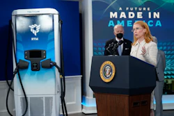 President Joe Biden listens as Jane Hunter, CEO of Tritium, speaks about electric vehicle chargers during an event in the South Court Auditorium in the Eisenhower Executive Office Building on the White House complex, Tuesday, Feb. 8, 2022, in Washington.