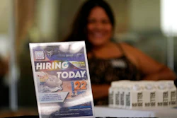 A hiring sign is placed at a booth for prospective employers during a job fair Wednesday, Sept. 22, 2021, in the West Hollywood section of Los Angeles. The number of Americans applying for unemployment benefits rose to the highest level in three months as the fast-spreading omicron variant disrupted the job market. Jobless claims rose for the third straight week — by 55,000 to 286,000, highest since mid-October, the Labor Department reported Thursday, Jan. 20, 2022.