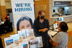 Marriott human resources recruiter Mariela Cuevas, left, talks to Lisbet Oliveros, during a job fair at Hard Rock Stadium, Friday, Sept. 3, 2021, in Miami Gardens, Fla.