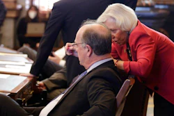Kansas state Sens. Jeff Longbine, left, R-Emporia, and Pat Pettey, D-Kansas City, confer as the Senate votes on a measure to allow the state to offer more than $1 billion in breaks to an unnamed company to bring a $4 billion project to Kansas, Wednesday, Feb. 9, 2022, at the Statehouse in Topeka, Kan. Both Longbine and Pettey supported the measure, which is designed to seal a deal with the company to create 4,000 jobs.