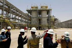 Saudi Aramco engineers and journalists look at the Hawiyah Natural Gas Liquids Recovery Plant, which is designed to process 4.0 billion standard cubic feet per day of sweet gas, a natural gas that does not contain significant amounts of hydrogen sulfide, in Hawiyah, in the Eastern Province of Saudi Arabia, June 28, 2021. Leaders of the world's most consequential energy bodies gathered for a forum Wednesday, Feb. 16, 2022, to discuss the uncertain future of oil as demand rebounds and prices climb, all while a growing roster of nations pledge to transition to cleaner forms of energy.