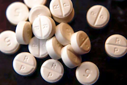 This June 17, 2019, file photo shows 5-mg pills of Oxycodone. Native American tribes in the U.S. have reached settlements worth $590 million over opioids. A court filing made Tuesday, Feb. 1, 2022 in Cleveland lays out the details of the settlements with drugmaker Johnson & Johnson and distribution companies AmerisoruceBergen, Cardinal Health and McKesson.