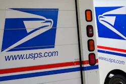 In this Aug. 18, 2020, file photo, mail delivery vehicles are parked outside a post office in Boys Town, Neb. The U.S. Postal Service says it has cleared the final regulatory hurdle to placing orders for next-generation mail vehicles. That keeps the Postal Service on track for taking delivery of the first of the electric- and gas-powered delivery vehicles next year. Postmaster General Louis DeJoy said Wednesday, Feb. 23, 2022 that the completion of an evaluation required by the National Environmental Policy Act is an important milestone for postal carriers who’ve soldiered on with overworked delivery trucks that went into service from 1987 to 1994.