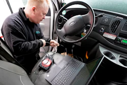 Brian Hohmann, mechanic and owner of Accurate Automotive, in Burlington, Mass., attaches a diagnostics scan tool, center left, to a vehicle and a laptop computer, below, Tuesday, Feb. 1, 2022, in Burlington. The diagnostics scan tool sends information from the vehicle's computer to the laptop so a mechanic can view information about the vehicle's performance.